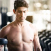Fit Teenage Young Man Shirtless Doing Hammer Curls Dumbbells Fitness