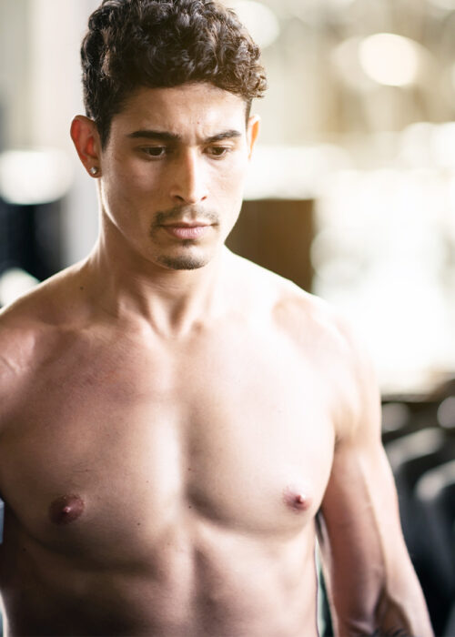 Fit Teenage Young Man Shirtless Doing Hammer Curls Dumbbells Fitness