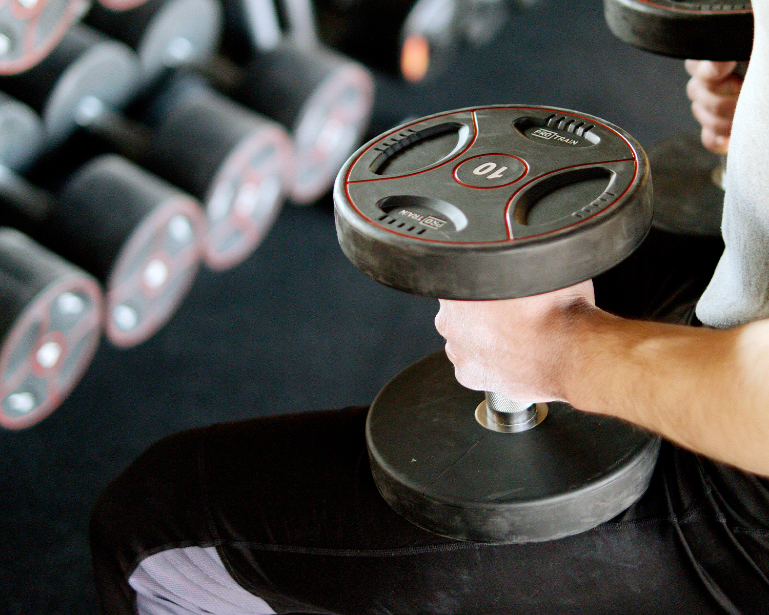 Man at Gym Holding Weights for Exercise