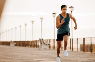 Fit Man Sprinting Exercising Down Boardwalk