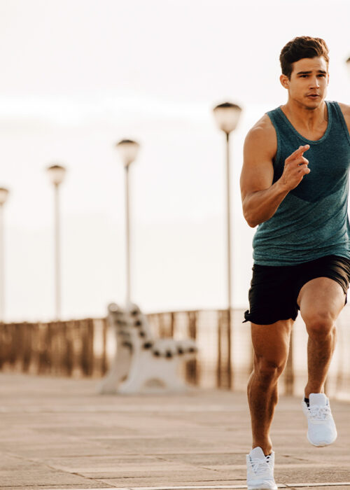 Fit Man Sprinting Exercising Down Boardwalk
