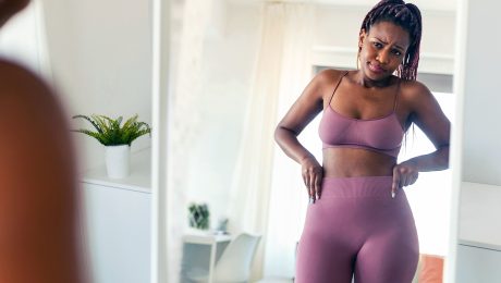 Fit Black African American Woman Looking in Mirror at Body