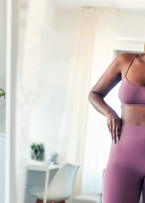 Fit Black African American Woman Looking in Mirror at Body
