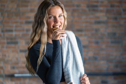 woman eating protein bar