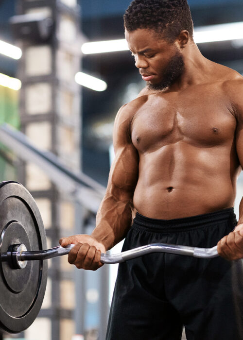 Man doing weighted curls in the gym
