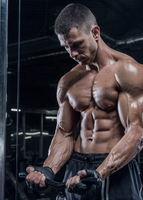 Muscular Tanned Guy Doing Cable Pull Ups
